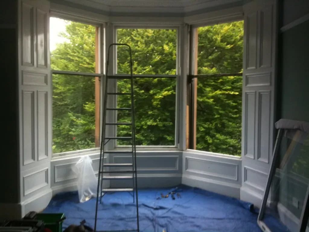 Modern living room with slim-framed aluminium windows letting in natural light