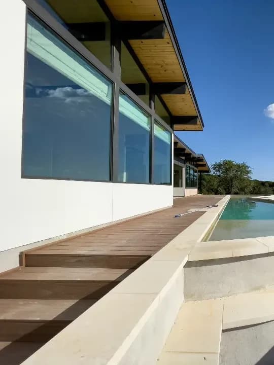 Modern coastal house with large aluminium glazing facing the sea