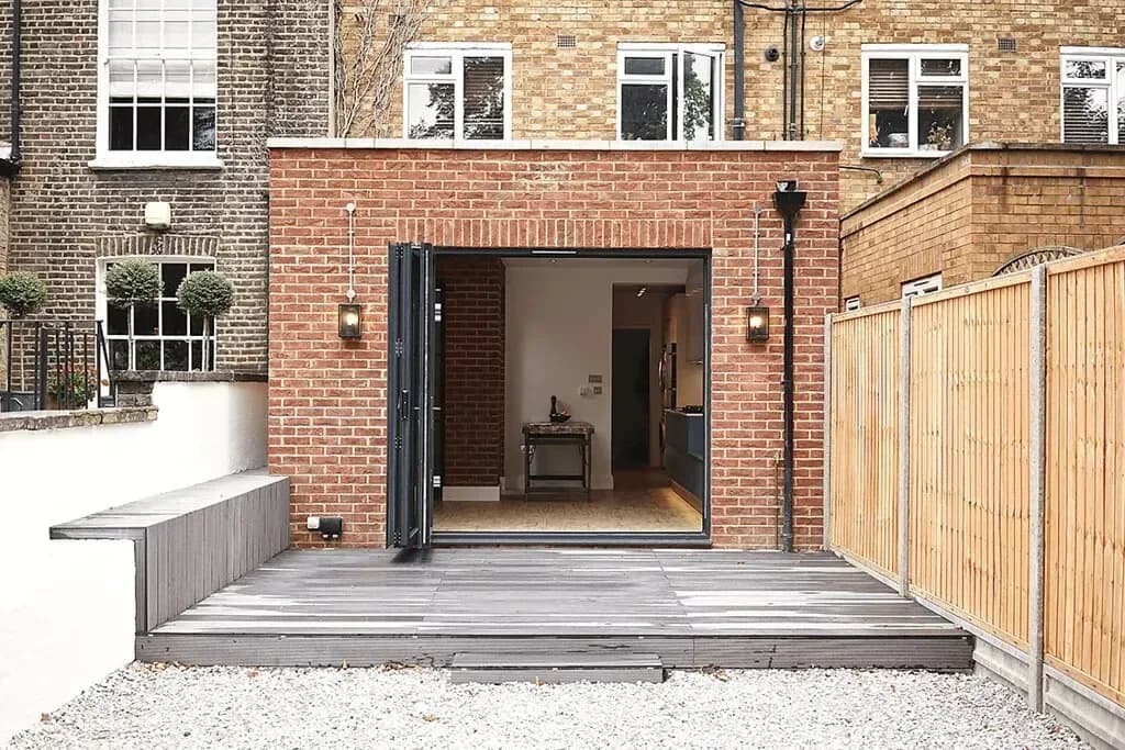 Aluminium bi-fold doors folded back from a kitchen extension