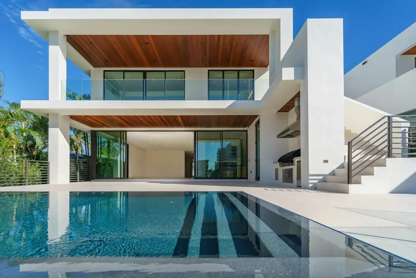 Large lift-and-slide aluminium door opening a living room to the garden